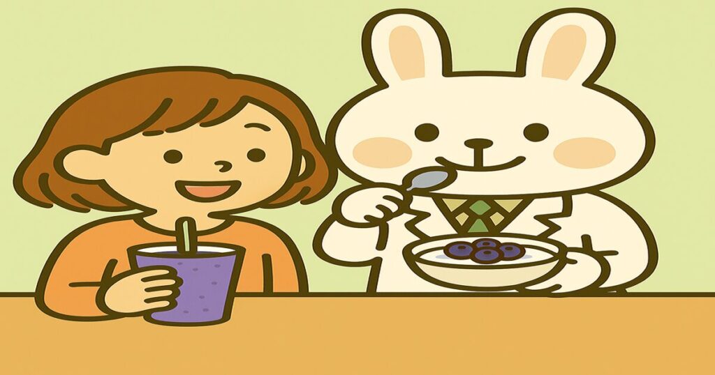 オレンジ色の服を着た“すずちゃん”と白衣姿の“みどりん”が、ブルーベリー入りヨーグルトとスムージーを手に、会話している様子。吹き出しが入っている。